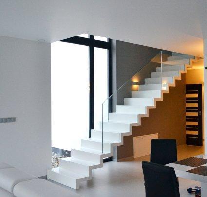 Białe schody ze szklaną balustradą